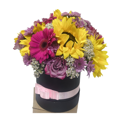 Caja Redonda de Girasoles Gerberas y Rosas en Tono Morado