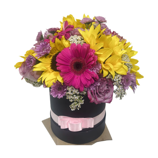 Caja Redonda de Girasoles Gerberas y Rosas en Tono Morado